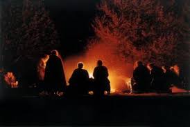Image result for people sitting around a campfire