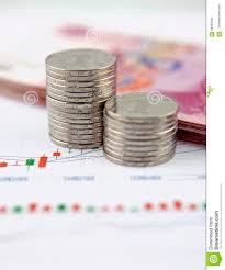 Coins And Chinese Currency On Chart Graphic Stock Photo
