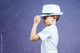 a little boy in a white hat and t shirt