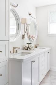 Vanity set that includes a table with lights and lighted mirror. Light Gray Double Bath Vanity With White Marble Convex Mirrors Transitional Bathroom