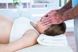 Male Therapist Performing Reiki Over Eyes Of Woman At Health Center Stock Photo, Picture And Royalty Free Image. Image 45379925.
