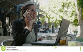 Business Woman Sitting In A Cafe Working On A Laptop Computer And