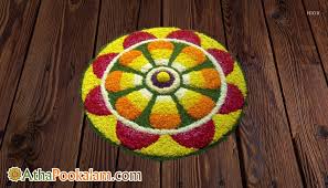 One of the popular and common pookalam design that you can't ignore this season as well is symmetric kolam design to adorn your. Small Athapookalam