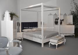 elegant four poster bed in glossy white