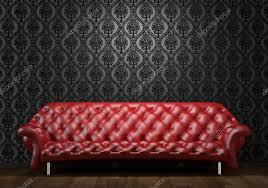 red leather couch on black wall stock