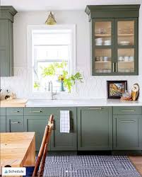 Chic vintage green kitchen design with mint green kitchen cabinets, green crown molding, farmhouse sink, marble counter tops, white kitchen island and subway tiles backsplash. Moody Green Kitchen Cabinet Paint Colors Bright Green Door