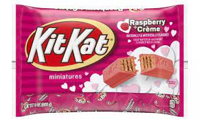 A man sat next to the little pile. New Raspberry Creme Kit Kats Debut For Valentine S Day Daily Mail Online