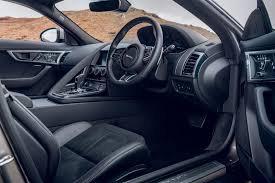 Available configurable ambient interior lighting comes in phosphor blue, pale blue, white, coral, or red. Jaguar F Type Interior Autocar