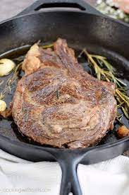 pan seared ribeye steak cooking with