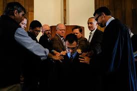 Image result for laying on of hands ordination