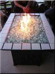 It's nice to sit around the fire without the to light the fire pit: How To Build A Propane Fire Pit Diy Propane Fire Pit Glass Fire Pit Fire Pit Table