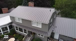 Charcoal gray wainscote on rigid frame metal building. Residential Roofing