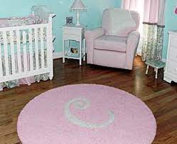 white nursery with custom initial rug