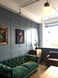 Dark Green Velvet Sofa With Blue Walls