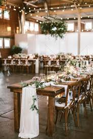 wooden tables and chairs at a wedding