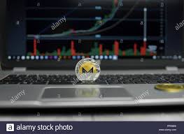 Golden And Silver Coin Of Monero On A Black Keyboard Of