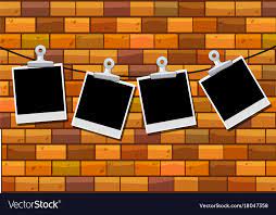 Photo Frames Hanging On Brick Wall