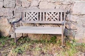 Old Wooden Bench Near A Stone Fence