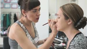 makeup artist making make up for young