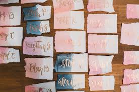 You can also drape them from tree branches or tack them to a wall. Unique Watercolor Calligraphy Escort Cards For Your Wedding Workshop Wedding Inspiration 100 Layer Cake