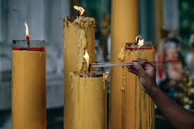 Lighting Incense Sticks From Big Yellow Candles Fancycrave