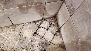 moldy natural stone shower floor and