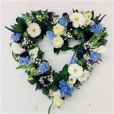 These funeral stands are all in the shape of hearts, showing your love for the person that has been lost. Pale Blue And White Open Heart Funeral Flowers Reading