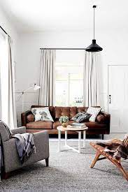 brown leather sofa with grey rug via