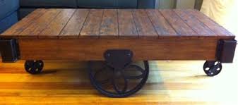Industrial railroad coffee table cart with shelf has 5 metal swivel casters and added lower shelf for storage. Factory Cart Coffee Table