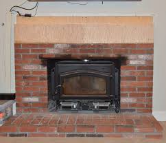 A Brick Fireplace With Wood Stone