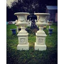cast iron urns on pedestals pair