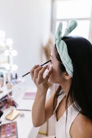 in mirror doing makeup free stock photo