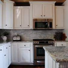 Kitchen cabinets hang at standard heights that relate to the position of the countertop and certain appliances. Microwave Above Stove With Raised Cabinet Above Kitchen Remodel Small Kitchen Design Best Kitchen Cabinets