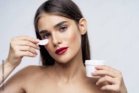 young woman applying makeup stock photo