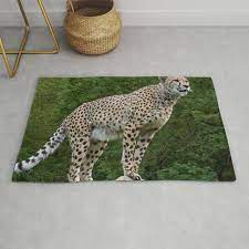 majestic cheetah standing on a log rug
