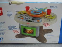 Four slices of pizza, pizza cutter, pizza tray, four cookies, cookie tray and two place settings (with fork, spoon, cup. New Fisher Price Servin Surprises Kitchen Table Kids Playset With Fun Sounds For Sale Online