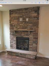 stacked stone fireplace with tv mount