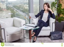 Young Asian Business Woman In Suit Looking At The Chart On