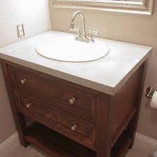 Two door white lacquer bath vanity with gold leaf hardware and white carrara marble top features: Diy Bathroom Vanity Diy Bathroom Concrete Vanity Diy Concrete Countertops Diy Bathroom Vanity