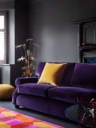 plush purple velvet sofa with mustard