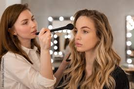 makeup artist applying bronzer on model