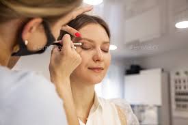 woman makeup artist doing makeup lady