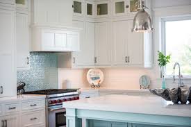 If you're redesigning your kitchen, you may have found yourself stuck on the corner cabinet. Coastal Style White Kitchen With Blue Island Crystal Cabinets