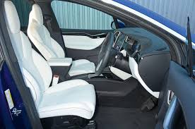 Tesla wants tethers on the outboard seats to go on the outside edge of the head restraint; Tesla Model X Interior Autocar