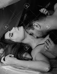 Young Beautiful Loving Couple Is Embracing On A Bed. Ntimate Image Of Sensual  Couple Foreplay, Kissing Passionately. Black And White Stock Photo, Picture  and Royalty Free Image. Image 101671907.
