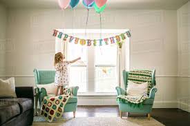 girl decorating balloons in living room