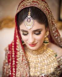 bride in a red and gold bridal outfit