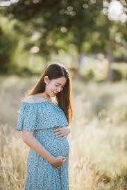 Premium Photo | Asian young pregnant woman in blue dress relaxing and  enjoying life in grass nature at summer day.
