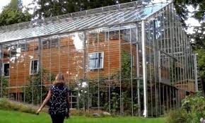 couple builds greenhouse around home to