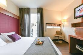 Guests praise the comfy beds. Appart City Hotel Paris Roomforday